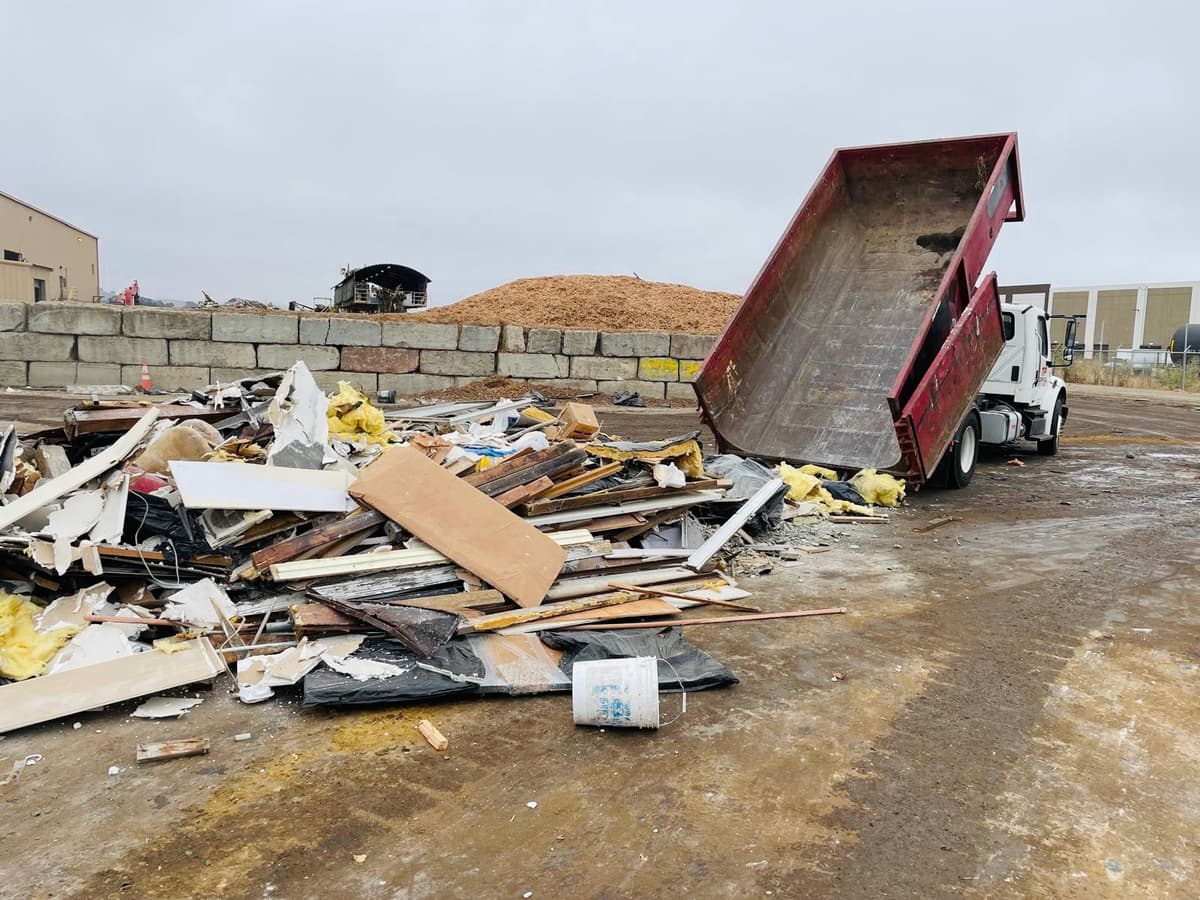 Roll-off dumpster being emptied at disposal facility