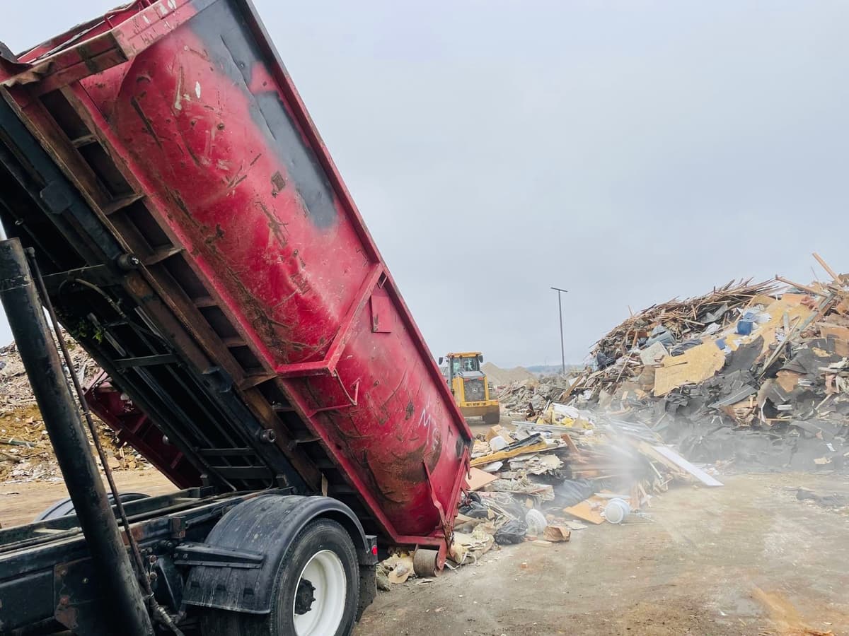 Active construction job site with roll-off dumpster for debris